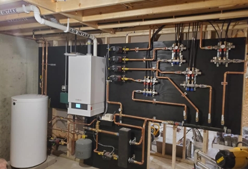 photo of plumbing install in a basement